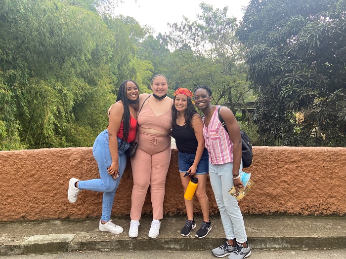 A group of four students posing for a picture at the Cali zoo.