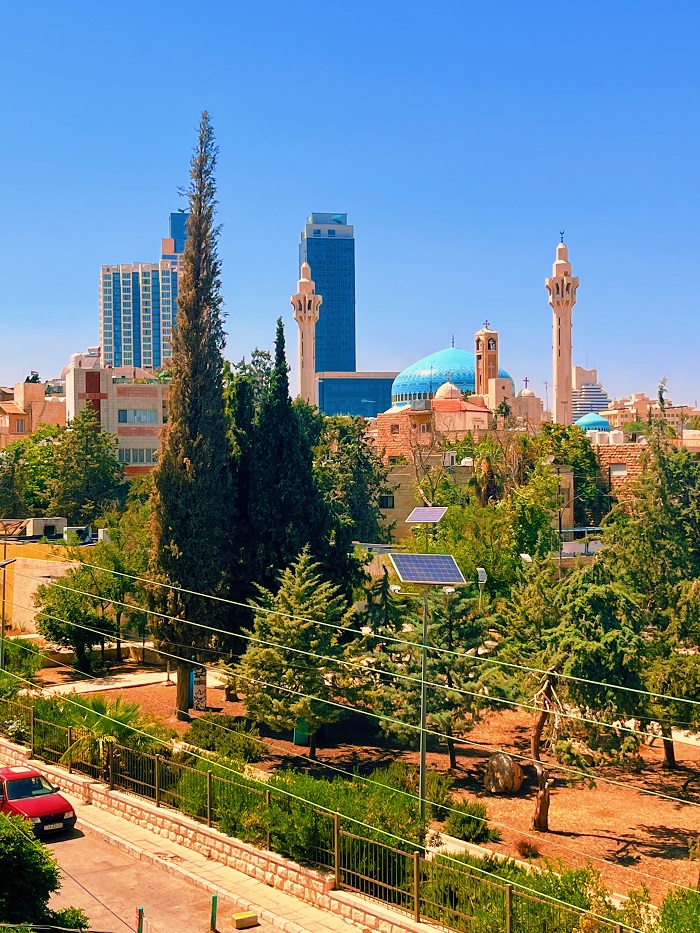 Amman skyline with a courtyard of trees and greenery