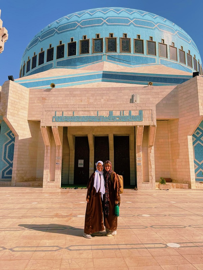 Grace and friend standing in front of mosque