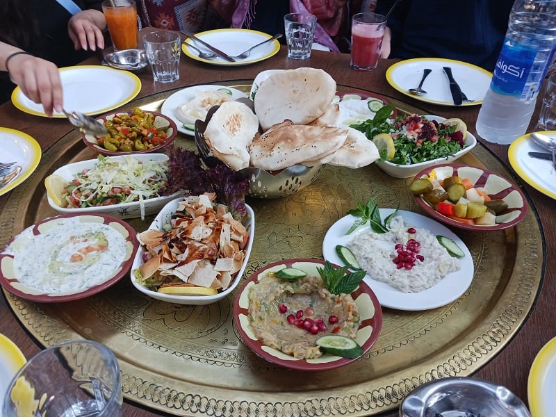 full spread of traditional jordanian dishes on table 