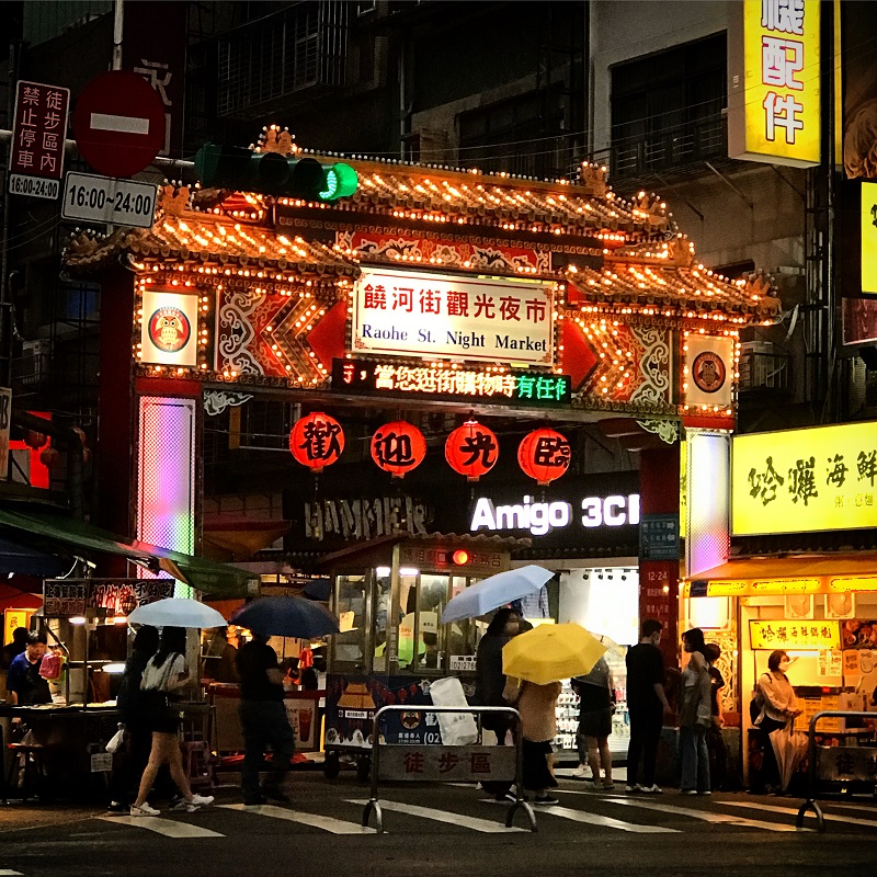 street view of outdoor market at night