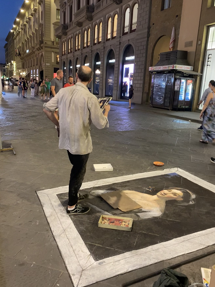 man standing on sidewalk over portrait of a woman 