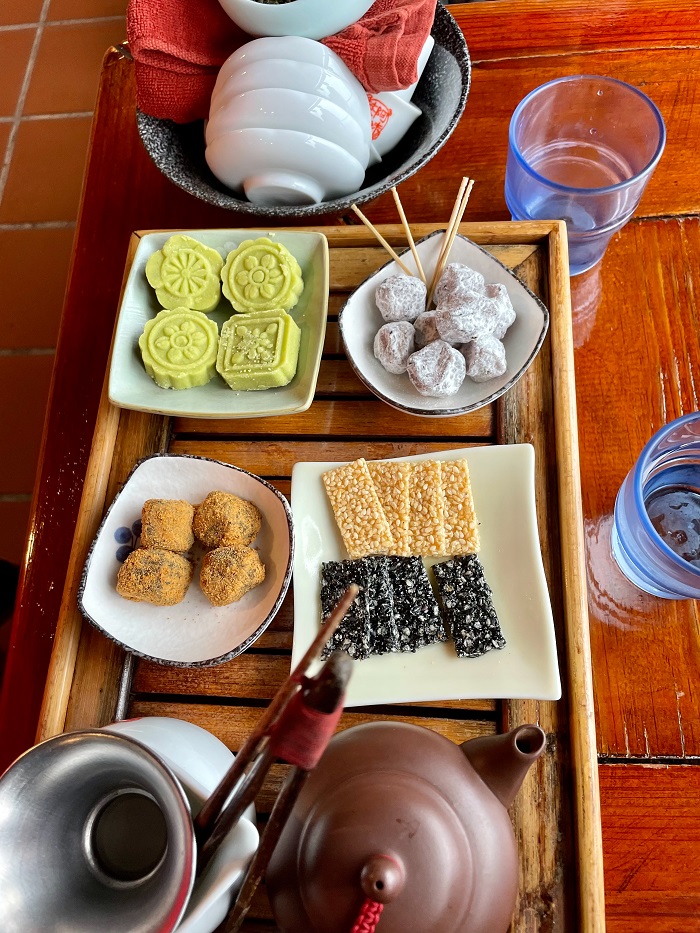 Various desserts and teapots on a table
