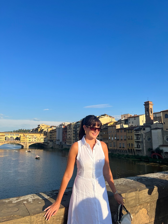 Grace posing on bridge in front of Arno river