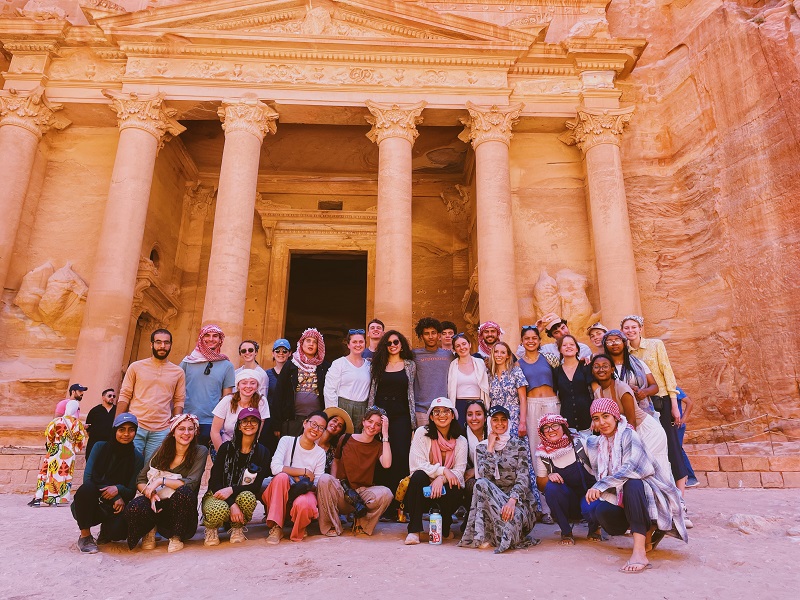 Big group of CET students posing in front of Treasury at Petra