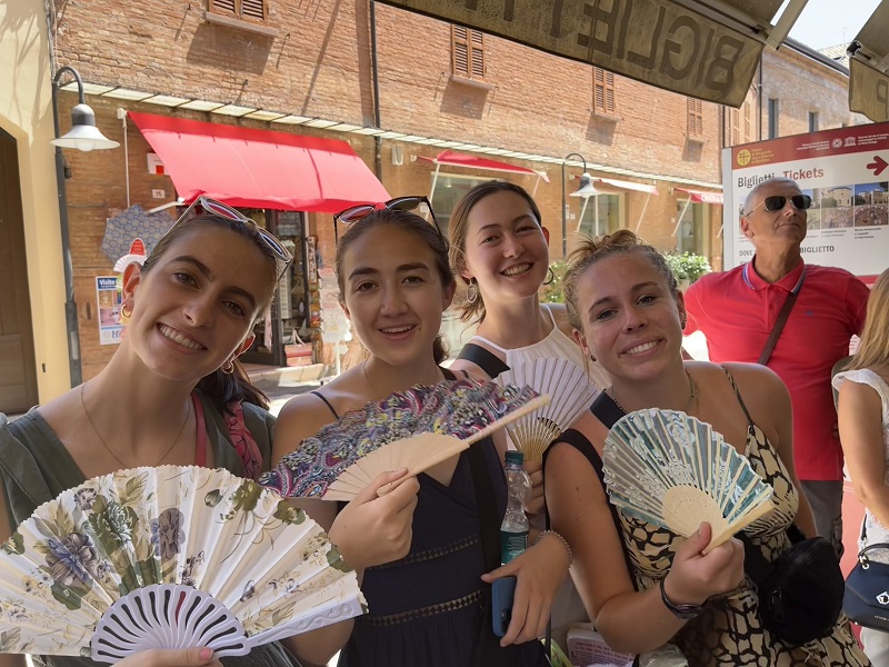 Sarah and friends holding paper fans 