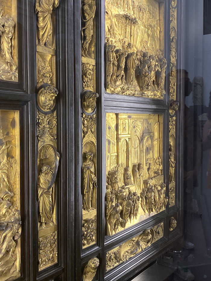 golden door with small raised scultpures