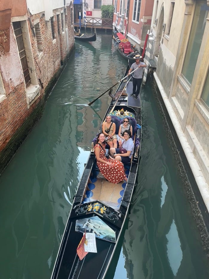Sarah and friends on a boat ride through street channels in Venice