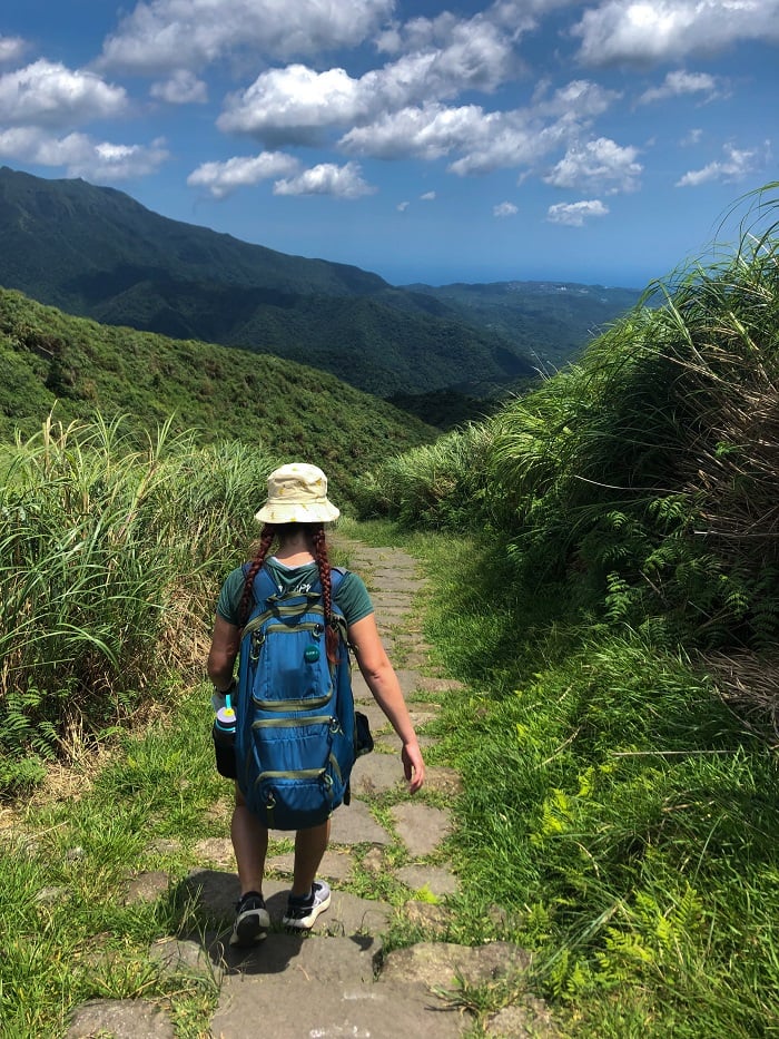 Hana walking downhill on mountain trail