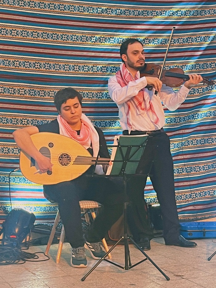Two musicians playing guitar and violin