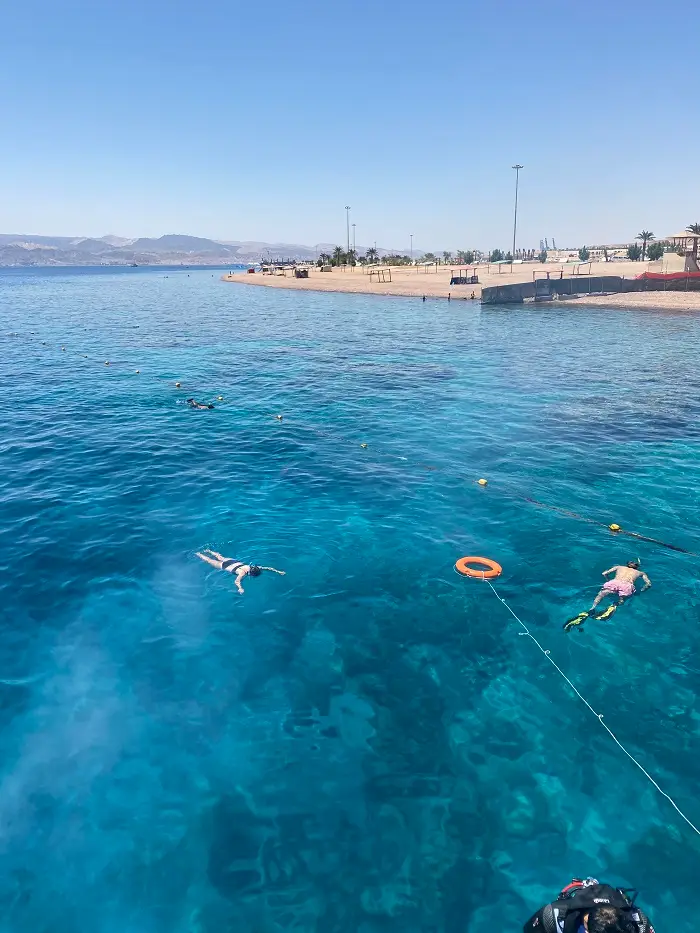 People snorkeling in crystal blue water