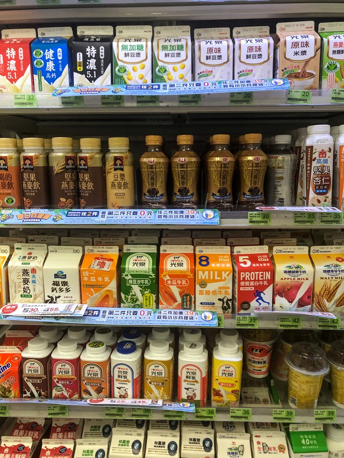 Shelf stocked with a variety of milk