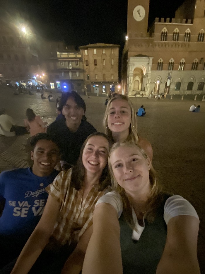 Sarah and her friends in the plaza at night