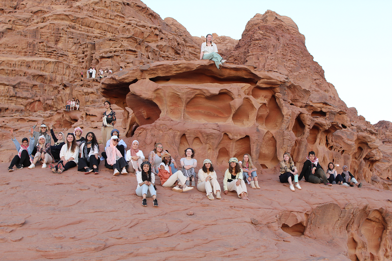students sitting on rock formations