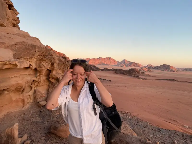 Meg next to rock formation in the desert