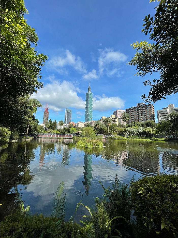 View of Taipei 101 and city skyline from a pond