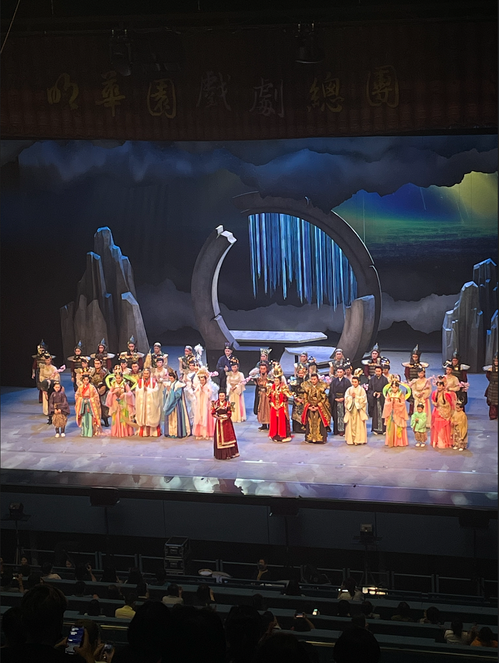  many actresses on a stage in elaborate costumes