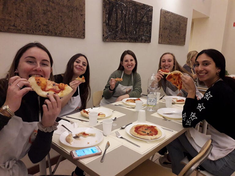 CET Florence study abroad students enjoy pizza made during a cooking class