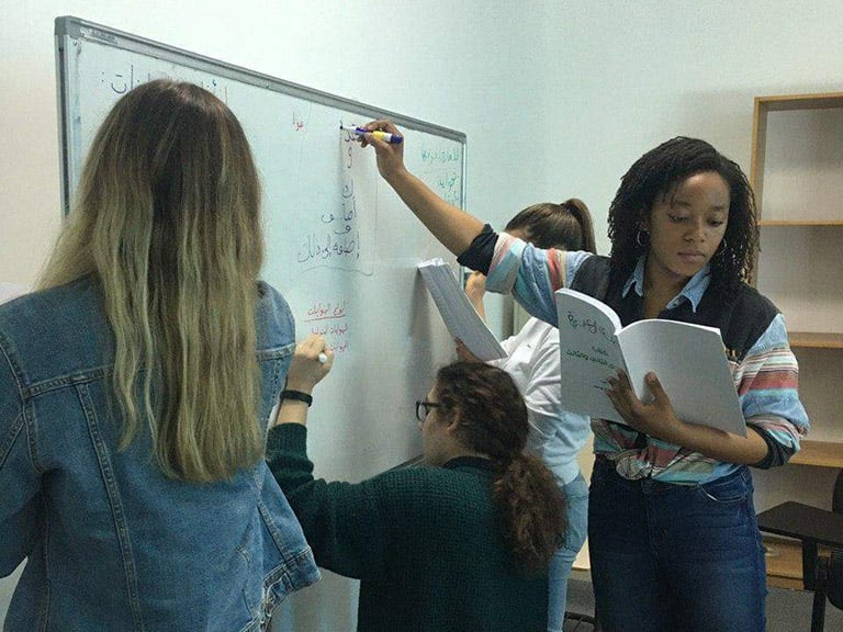 CET Jordan students complete an Arabic exercise on a whiteboard