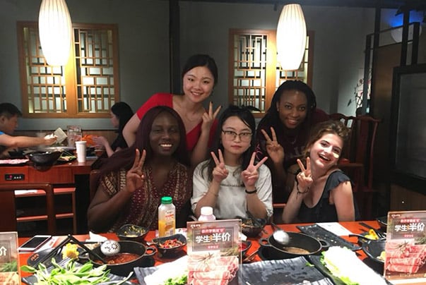 CET Shanghai students and local roommates at a restaurant