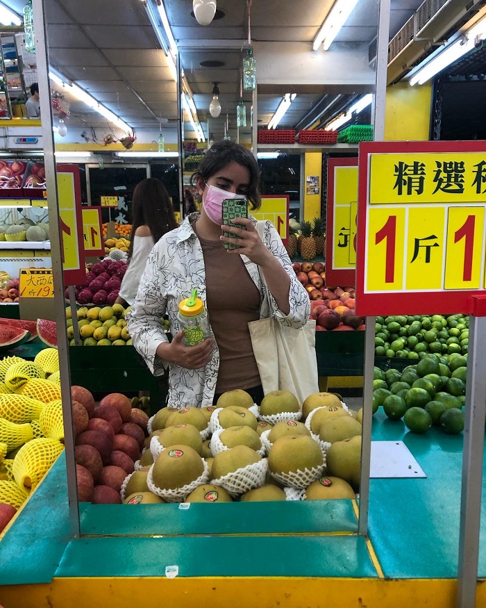 Mirror selfie of elissa at fruit store 