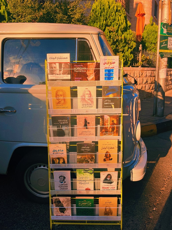 Books on a shelf in front of a Volkswagen