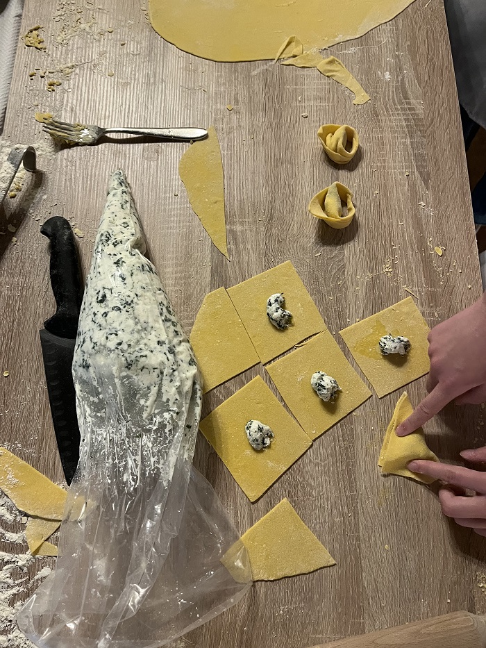 folding dought and filling into pasta