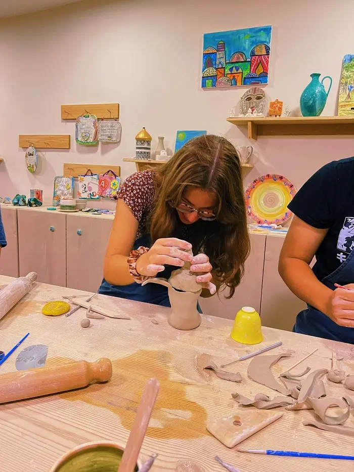 Grace making pottery