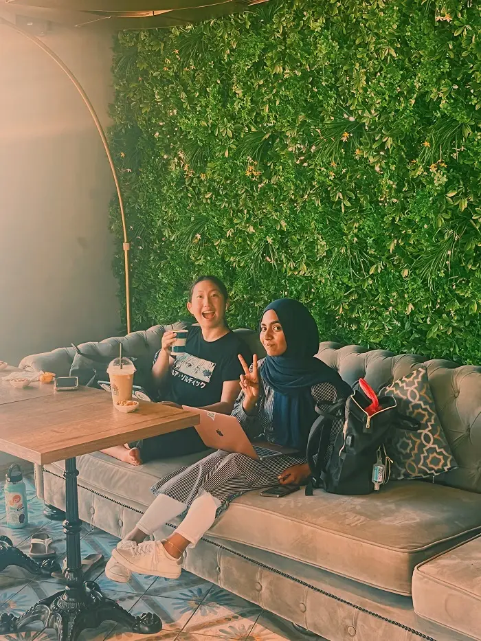 Kelly and Tashina sitting on couch in Café