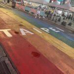 A paved street painted with a rainbow and the word "Taipei" written across it