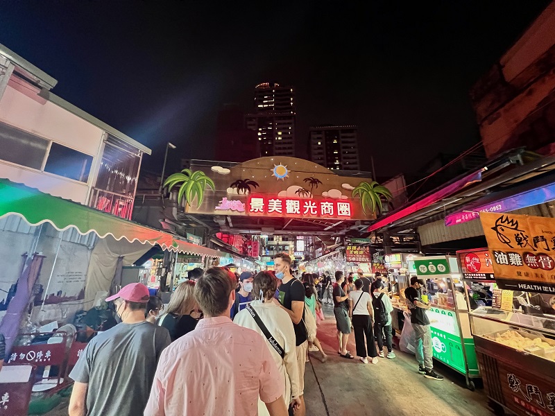 Many people standing by food stalls at Jingmei Night Market in Taiwan