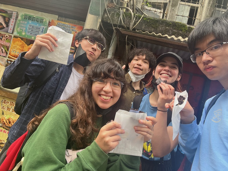 Students smiling with brownies in their hands