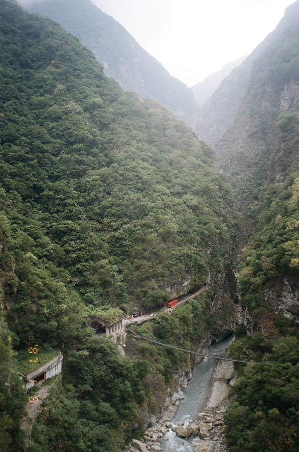 A suspended bridge crossing through a steep gorge.