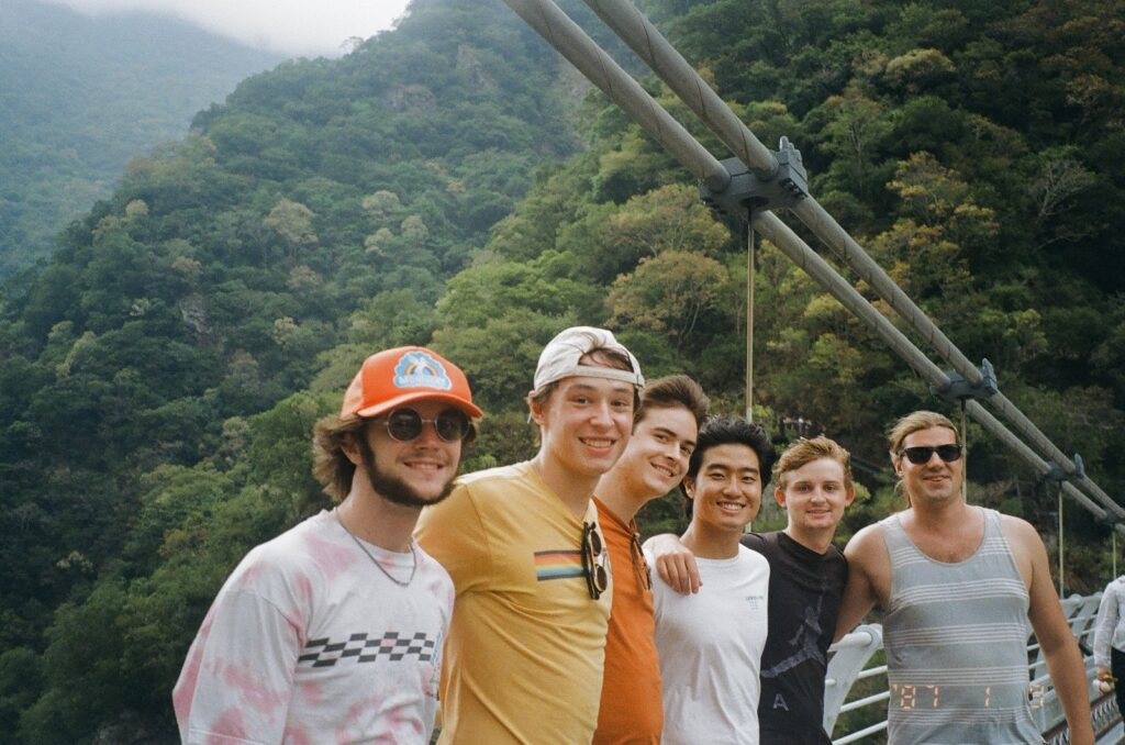 Six students posing on a suspension bridge in Taroko Gorge