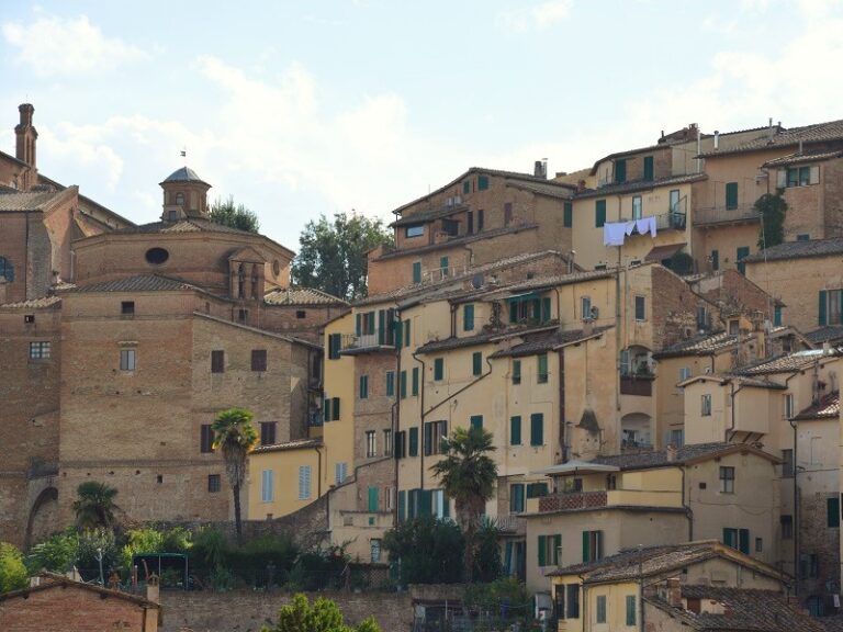 A wide shot of Siena's residential buildings stacked on a hill
