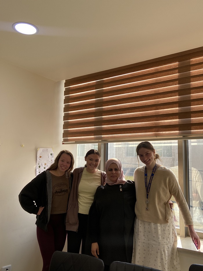 Three female students and their professor in Amman