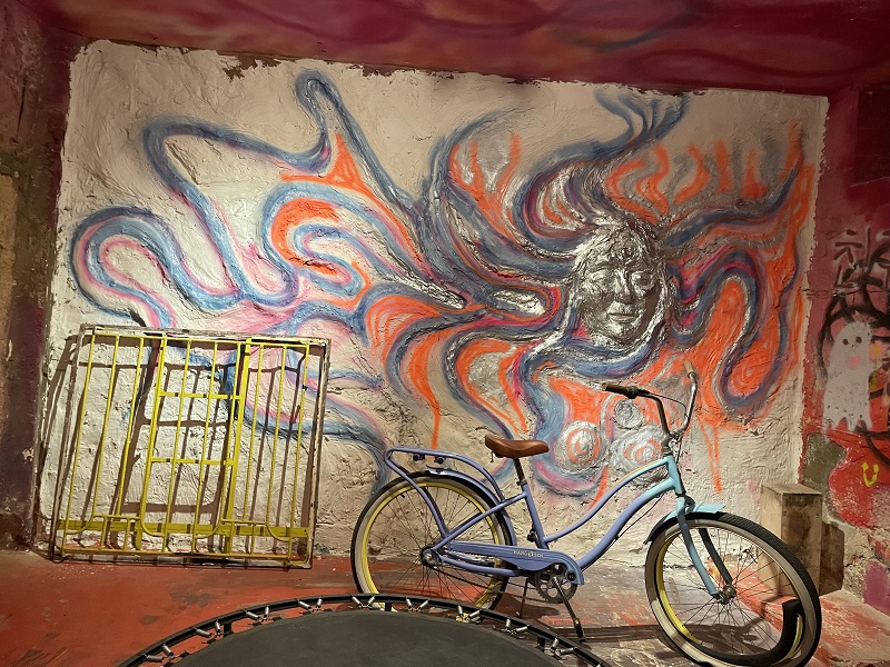 A bike in front of a mural art in Amman