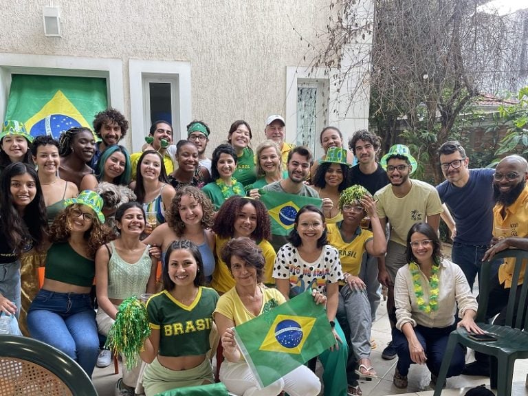 Students, faculty, and staff posing for a photo during a World Cup 2022 watch party.
