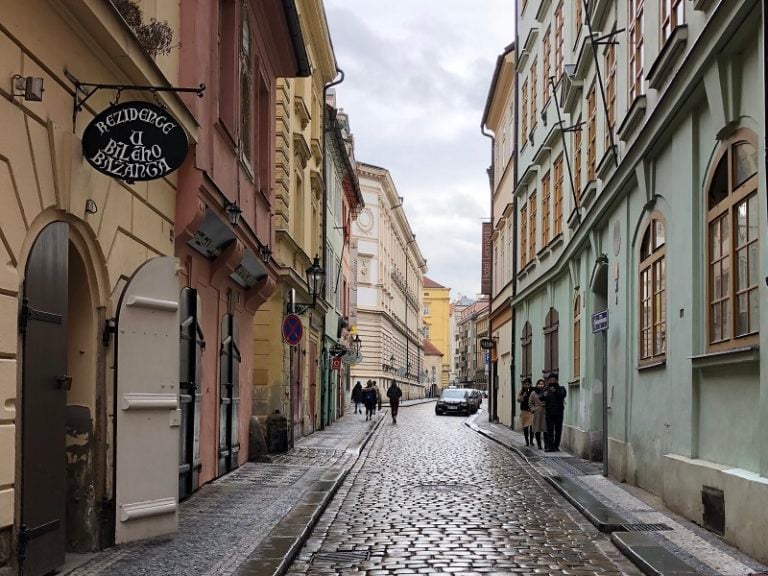 A cobblestone street on a cloudy day in Prague.