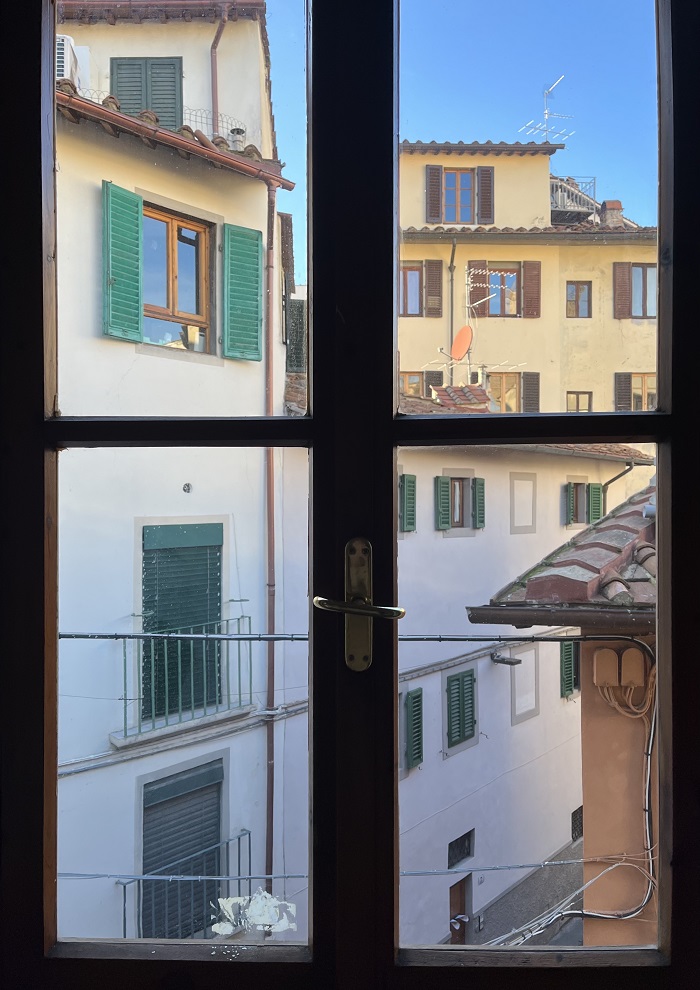 A window looking out to other buildings in Florence, Italy