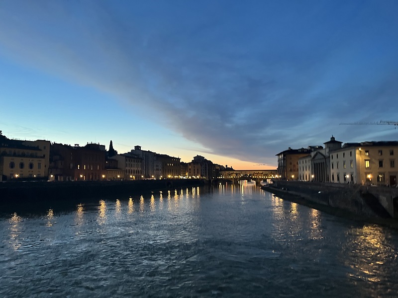 Sunset at the Arno River and Ponte Vecchio in the distance