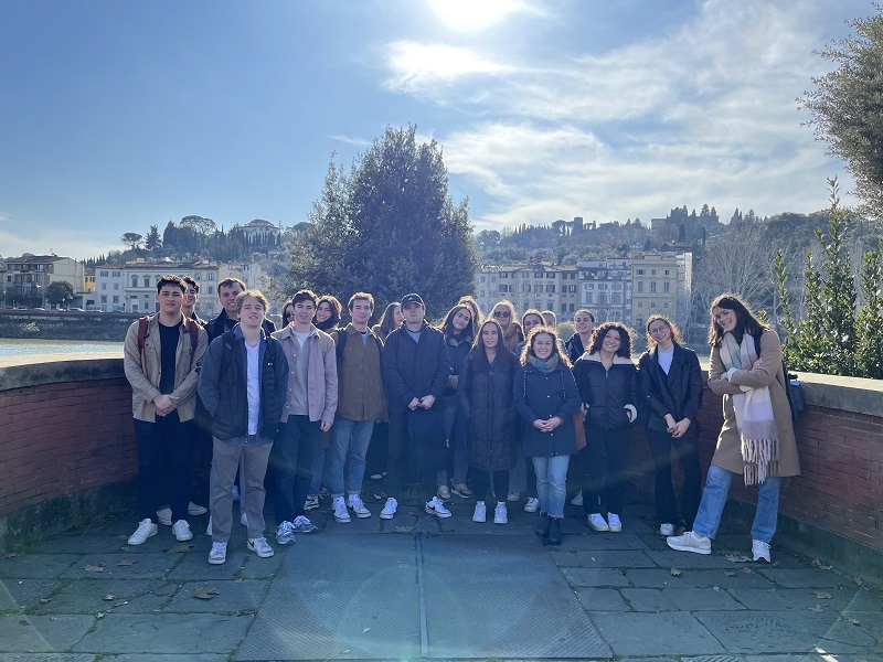 CET students posing in front of the Arno river in Florence while in class