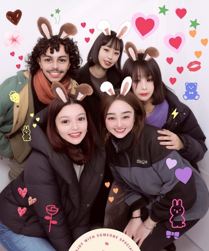 Five students in a Japanese photo booth with enhanced features