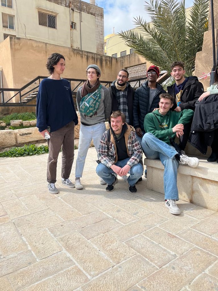 A group of male CET Jordan students posing outdoors