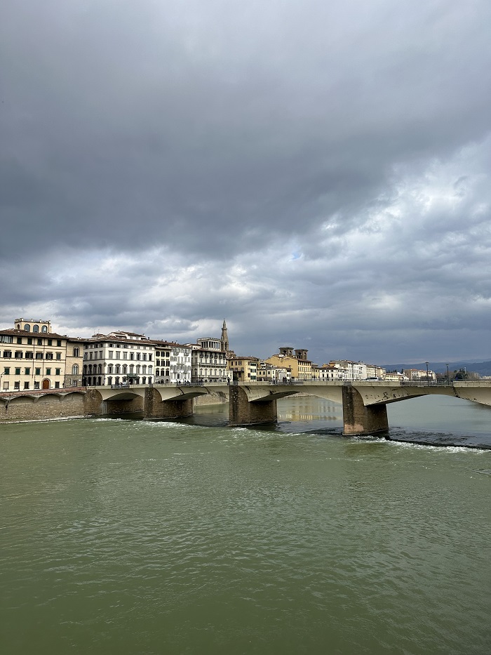 The Arno River and a bridge in Florence,  Italy on a grey and cloudy day,