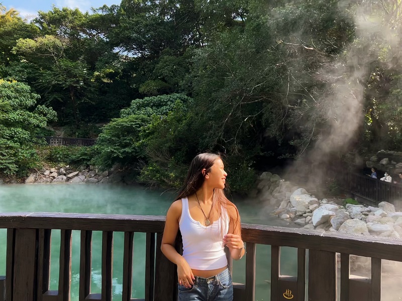 A CET Taiwan student standing in front of Beitou hot springs while looking off to the side