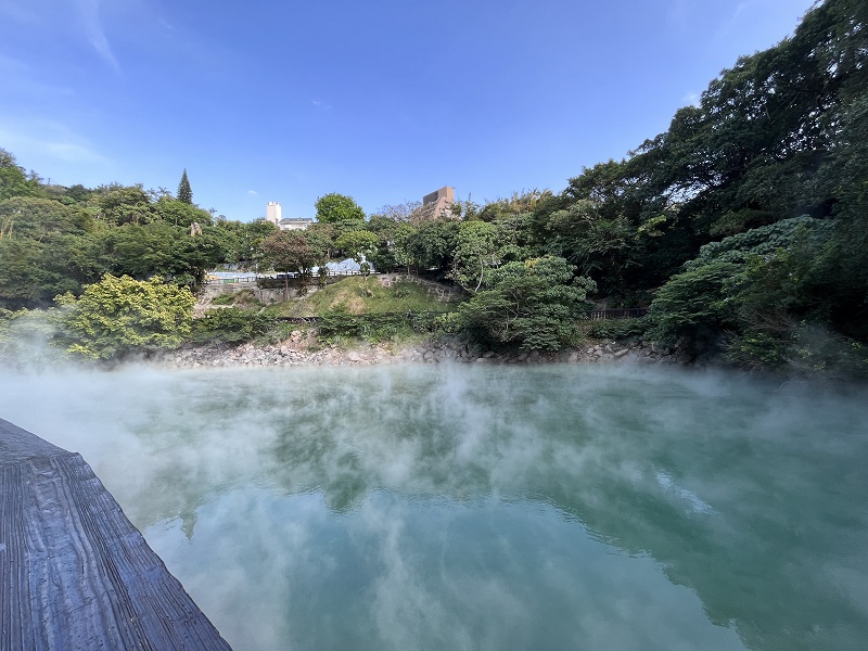 The blue Beitou hot springs and white smoke hovering right above the water