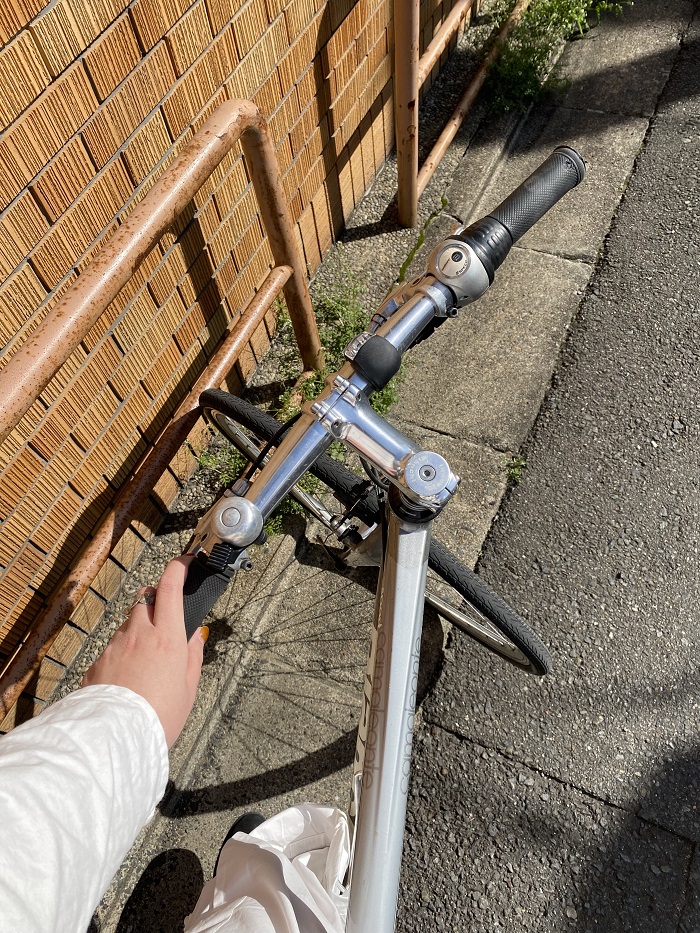 A hand holding the handle of a bike 