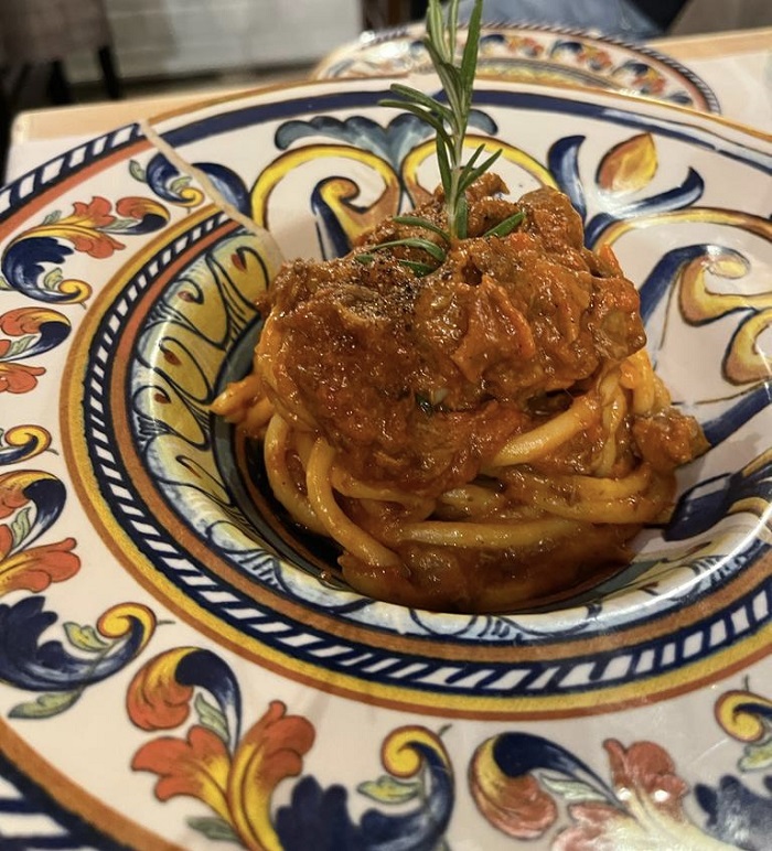 Close-up of a red pasta from a restaurant called Cacio e Pepe
