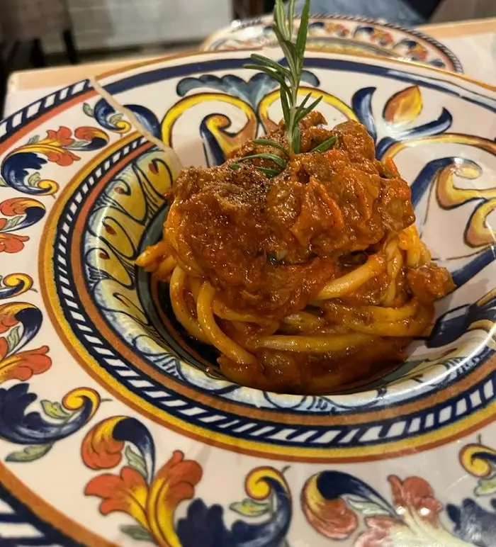 Close-up of a red pasta from a restaurant called Cacio e Pepe